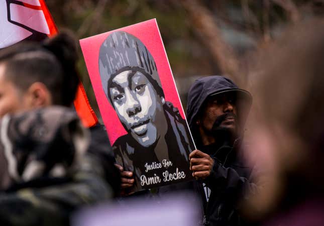 MINNEAPOLIS, MN - APRIL 06: A man holds a portrait of Amir Locke during a news conference outside the Hennepin County Government Center on April 6, 2022 in Minneapolis, Minnesota. Hennepin County Attorney Mike Freeman and Attorney General Keith Ellison announced today that no charges would be filed against the Minneapolis police officer who shot and killed Locke while serving a no-knock search warrant at the apartment in which Locke was sleeping earlier this year. (