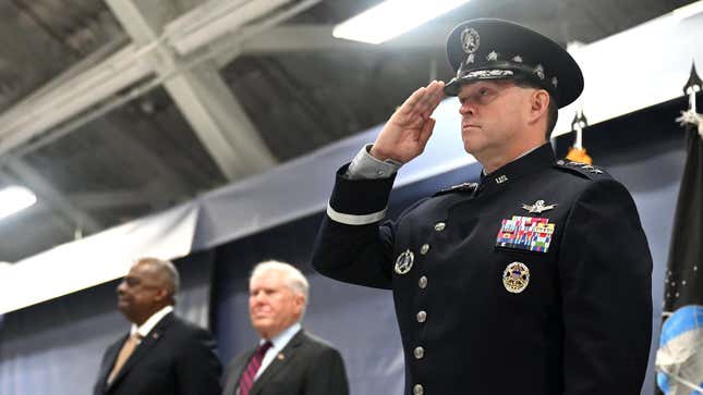 Chief of Space Operations Bradley Chance Saltzman stands in full dress uniform, staring ahead and saluting.