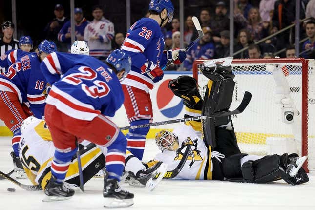 Mar 18, 2023; New York, New York, USA; Pittsburgh Penguins goaltender Tristan Jarry (35) guards the net against New York Rangers center Vincent Trocheck (16) and left wing Chris Kreider (20) and defenseman Adam Fox (23) during the first period at Madison Square Garden.