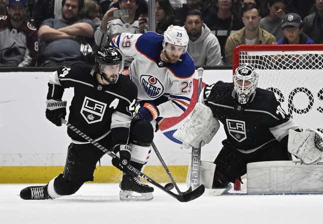 Apr 21, 2023; Los Angeles, California, USA; Los Angeles Kings goaltender Joonas Korpisalo (70) defends the net as center Phillip Danault (24) clears the puck in front of Edmonton Oilers center Leon Draisaitl (29) in the second period of game three of the first round of the 2023 Stanley Cup Playoffs at Crypto.com Arena.