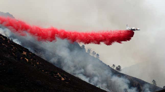 An air tanker drops fire retardant along the ridge line above Lake McClure on July 20, 2017.