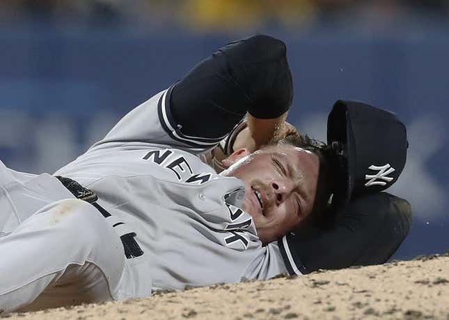 Sep 15, 2023; Pittsburgh, Pennsylvania, USA;  New York Yankees relief pitcher Anthony Misiewicz (54) reacts after being hit in the head by a line drive off the bat of Pittsburgh Pirates second baseman Ji Hwan Bae (not pictured) during the sixth inning at PNC Park. Misiewicz would leave the game.Mandatory Credit: Charles LeClaire-USA TODAY Sports
