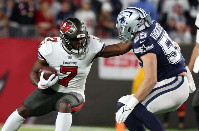Jan 16, 2023; Tampa, Florida, USA; Tampa Bay Buccaneers running back Leonard Fournette (7) rushes the ball against the Dallas Cowboys linebacker Leighton Vander Esch (55) in the first half during the wild card game at Raymond James Stadium.