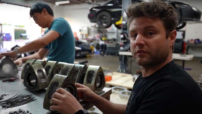 Rob Dahm sits in front of a bunch of Mazda rotors looking slightly overwhelmed