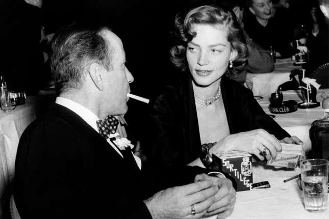 FILE - In this Feb. 1950 file photo actor Humphrey Bogart, left, and his wife, actress Lauren Bacall, appear at the Stork Club in New York. Bacall, the sultry-voiced actress and Humphrey Bogarts partner off and on the screen, died Tuesday, Aug. 12, 2014 in New York. She was 89. (AP Photo, File)