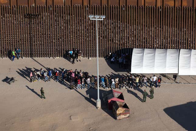 YUMA, ARIZONA - SEPTEMBER 28: Immigrants await processing by U.S. Border Patrol agents while seeking asylum in the United States on September 28, 2022, near Yuma, Arizona. U.S. immigration authorities made more than 2 million arrests along the U.S. southern border during the 2022 fiscal year, which ends September 30, the first time to reach that historical threshold.