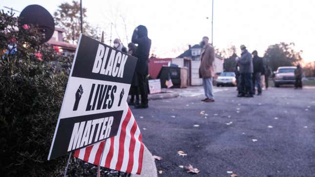 A Black Lives Matter sign outside next to an American flag is seen at a polling station in the King Arts Complex on November 3, 2020 in Columbus, Ohio. 