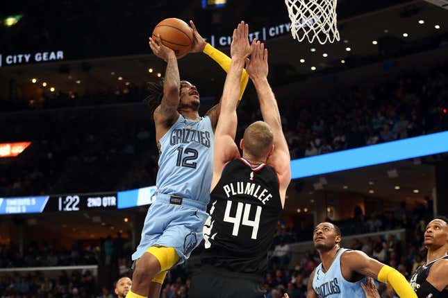 Mar 29, 2023; Memphis, Tennessee, USA; Memphis Grizzlies guard Ja Morant (12) shoots as Los Angeles Clippers center Mason Plumlee (44) defends during the first half at FedExForum.