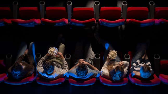 aerial view of 5 people sitting in a dark movie theater