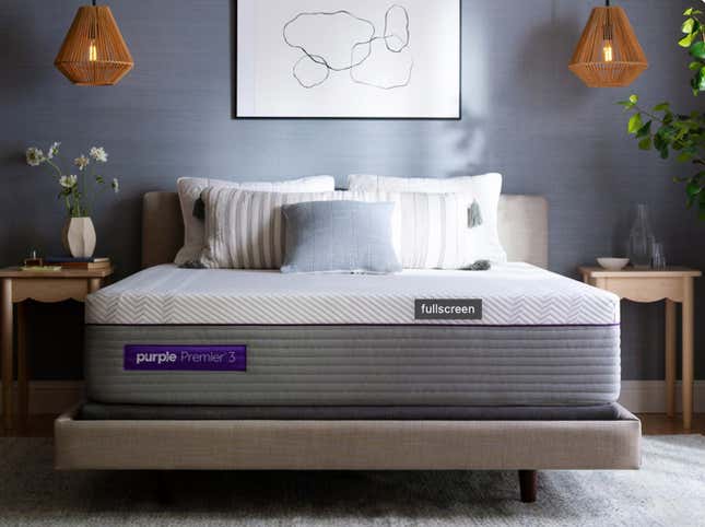 A Purple Premier 3 Mattress with several pillows in a modern bedroom. 