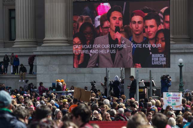 Crowds at US Navy Memorial Plaza watchs as David Hogg, a survivor of the Parkland shooting speaks