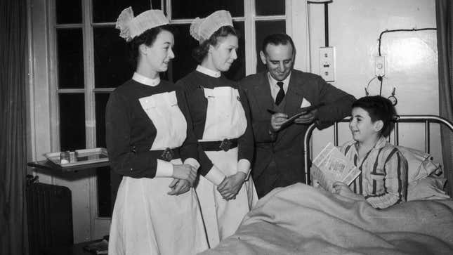 Two nurses attend a young hospital patient in this 1952 photo.