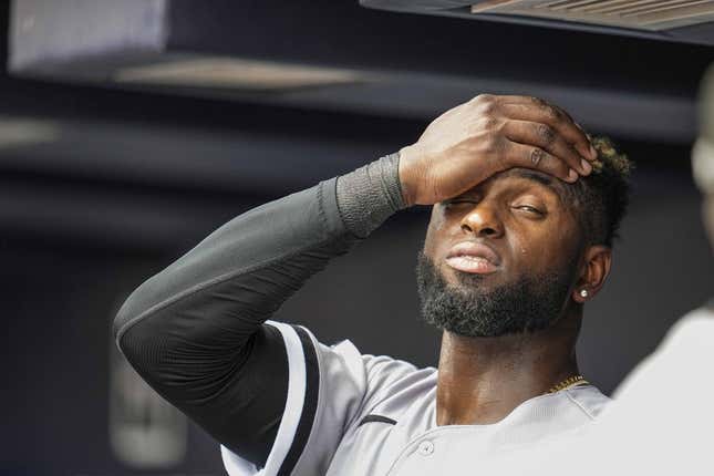 Jul 16, 2023; Cumberland, Georgia, USA; Chicago White Sox center fielder Luis Robert Jr. (88) reacts while standing under the air conditioner vent in the dugout against the Atlanta Braves during the seventh inning at Truist Park.