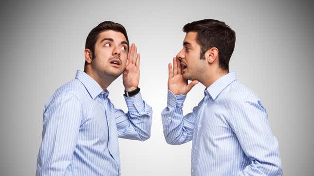 A man in a button up shirt talking to a clone of himself.