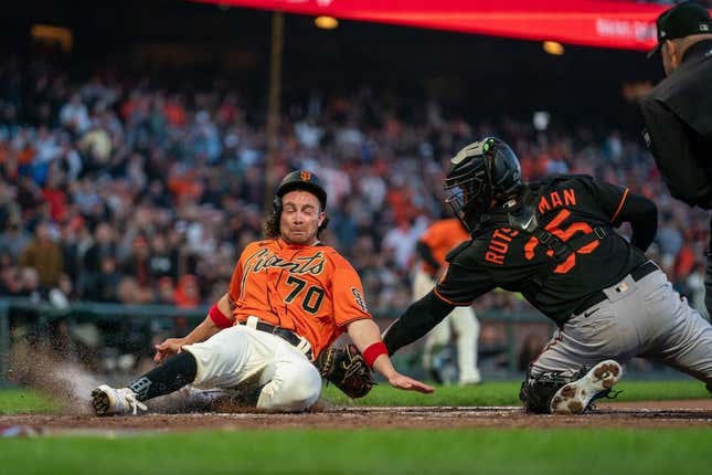 Jun 2, 2023; San Francisco, California, USA; San Francisco Giants center fielder Brett Wisely (70) is tagged out by Baltimore Orioles catcher Adley Rutschman (35) during the third inning at Oracle Park.