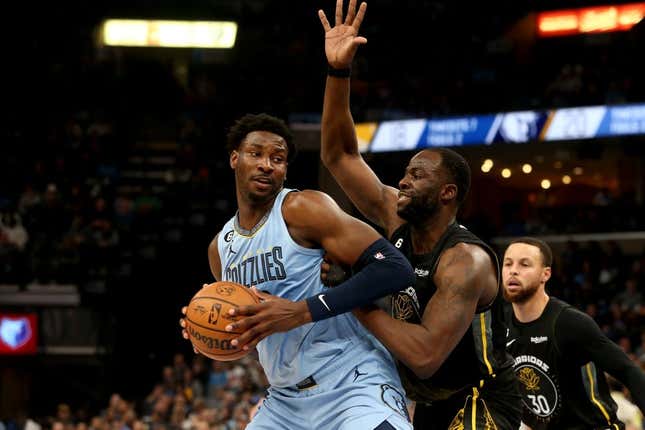 Mar 18, 2023; Memphis, Tennessee, USA; Memphis Grizzlies forward Jaren Jackson Jr. (13) spins toward the basket as Golden State Warriors forward Draymond Green (23) defends during the first half at FedExForum.