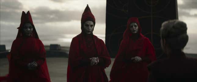 Three Nightsisters stand with their hands clasped.