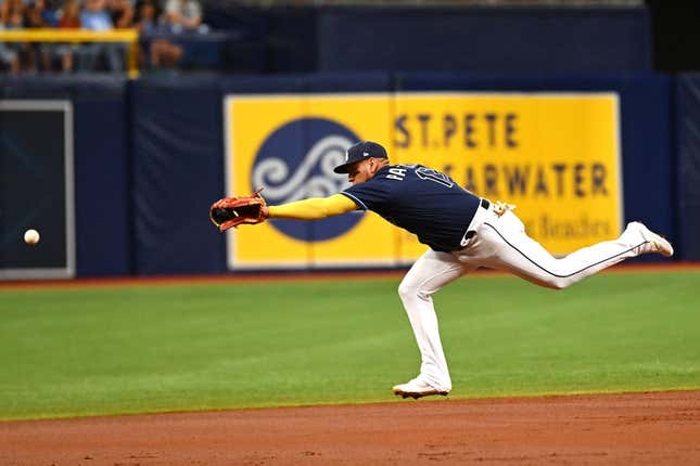 Jul 25, 2023; St. Petersburg, Florida, USA; Tampa Bay Rays third baseman Isaac Paredes (17) reaches for a line drive in the second inning against the Miami Marlins  at Tropicana Field.