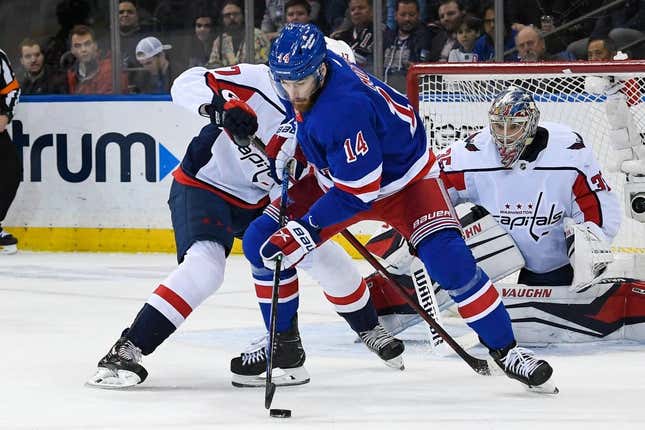 Mar 14, 2023; New York, New York, USA;  New York Rangers center Tyler Motte (14) plays the puck defended by Washington Capitals center Dylan Strome (17) during the first period at Madison Square Garden.