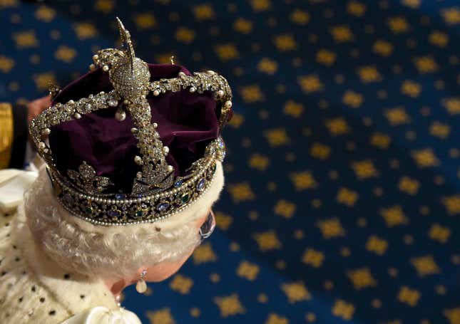 Queen Elizabeth II proceeds through the Royal Gallery after she addressed the State Opening of Parliament in the House of Lords at the Palace of Westminster on May 18, 2016 in London, England.
