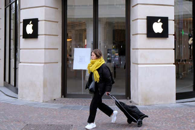 FILE - A woman walks past a closed Apple Store in Lille, northern France, Monday, March 16, 2020. A French watchdog ordered Apple to withdraw the iPhone 12 from the market because it is emitting too high levels of electromagnetic radiation. The National Frequencies Agency (ANFR), the body monitoring public exposure to radiations, called on Apple to &quot;implement all available means to rapidly fix this malfunction,&quot; in a statement released on Tuesday Sept.12, 2023. (AP Photo/Michel Spingler, File)