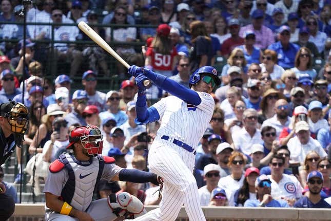 Jul 23, 2023; Chicago, Illinois, USA; Chicago Cubs center fielder Cody Bellinger (24) hits a one run sacrifice fly against the St. Louis Cardinals during the third inning at Wrigley Field.