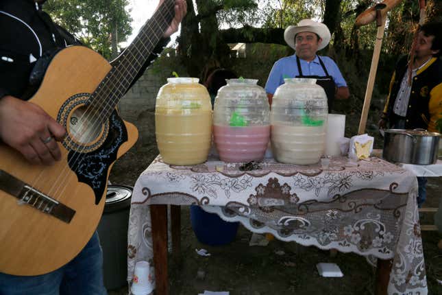 A pulque vendor with various flavors for sale at a pulque celebration in Santiago Cuautlalpan, Mexico.