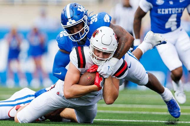 Sep 2, 2023; Lexington, Kentucky, USA; Ball State Cardinals tight end Tanner Koziol (88) is tackled by Kentucky Wildcats linebacker Trevin Wallace (32) during the first quarter at Kroger Field.
