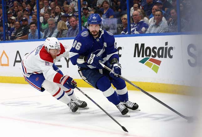 Mar 18, 2023; Tampa, Florida, USA; Tampa Bay Lightning right wing Nikita Kucherov (86) skates with the puck as Montreal Canadiens defenseman Mike Matheson (8) defends during the first period at Amalie Arena.