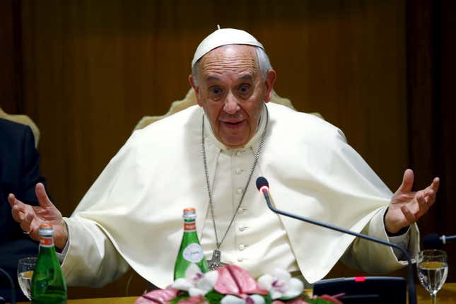 Pope Francis gestures as he speaks during the "Modern Slavery and Climate Change" conference at the Vatican