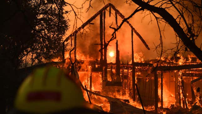 The frame of a house still stands as it burns in front of the rising sun during the Kincade Fire in Healdsburg, California on Oct. 27, 2019.