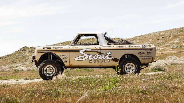A customized 1976 Scout Terra campaigned in the 2023 NORRA Mexican 1000 event by Anything Scout Vintage Racing Team poses in a field.