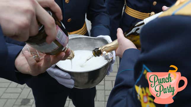 Men in uniform pouring champagne into a large bowl