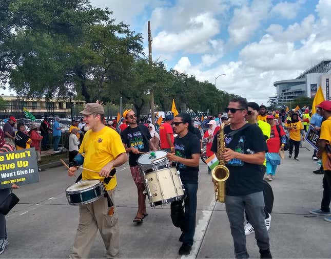 Protestors play musical instruments outside the Howdy, Modi! event venue in Houston, Texas.