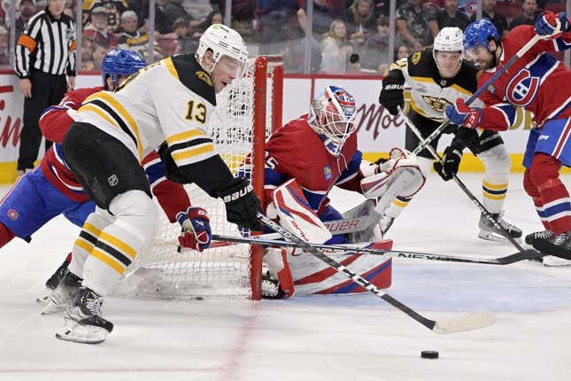 Apr 13, 2023; Montreal, Quebec, CAN; Boston Bruins forward Charlie Coyle (13) plays the puck near the net of Montreal Canadiens goalie Sam Montembeault (35) during the third period at the Bell Centre.