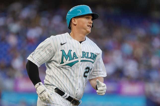 Mar 31, 2023; Miami, Florida, USA; Miami Marlins designated hitter Garrett Cooper (26) runs toward third base after hitting a triple during the first inning against the New York Mets at loanDepot Park.