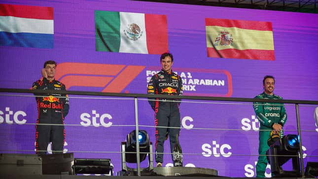 A photo of Max Verstappen, Sergio Perez and Fernando Alonso on the F1 podium. 