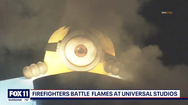 Universal Studios' giant Minion overlooks fire.