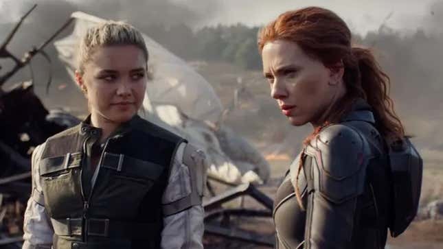 Florence Pugh and Scarlett Johansson's Yelena Belova and Natasha Romanoff stand among the ruins of a crashed aerial platform in a scene from Black Widow.
