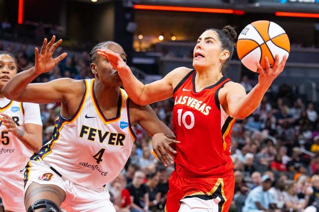 Jun 4, 2023; Indianapolis, Indiana, USA; Las Vegas Aces guard Kelsey Plum (10) shoots the ball while Indiana Fever center Queen Egbo (4) defends in the second half at Gainbridge Fieldhouse.