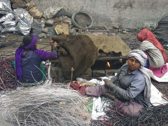Women extracting copper from electrical wires, in a highly polluting process.