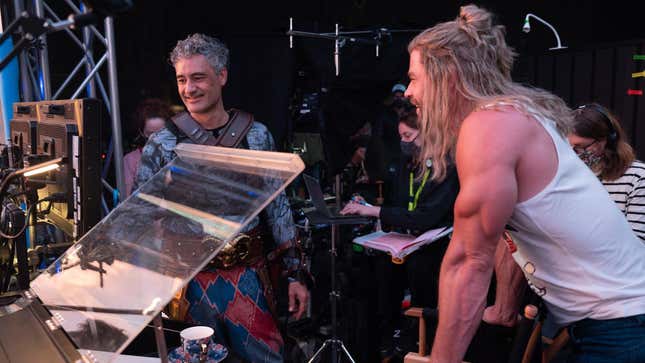 (from left) Taika Waititi lines up a shot with Chris Hemsworth on the set of Thor: Love And Thunder. 