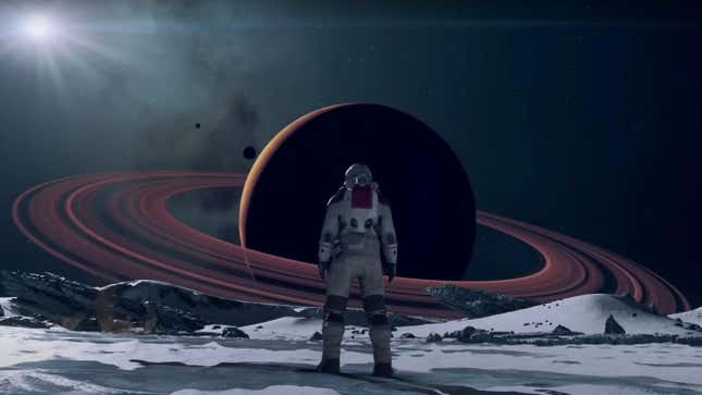 A Starfield protagonist stands in front of a shadowy ringed planet.