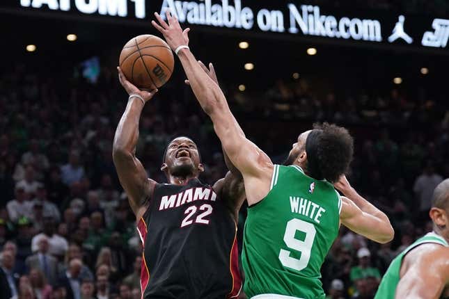 May 29, 2023; Boston, Massachusetts, USA; Miami Heat forward Jimmy Butler (22) shoots against Boston Celtics guard Derrick White (9) in the second quarter during game seven of the Eastern Conference Finals for the 2023 NBA playoffs at TD Garden.