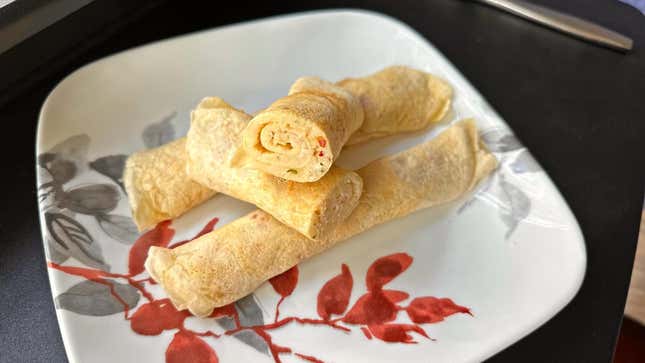 Pancake rolls stacked on a plate.