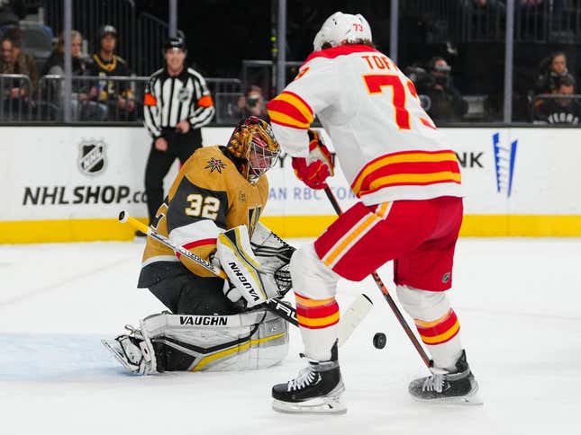 Mar 16, 2023; Las Vegas, Nevada, USA; Vegas Golden Knights goaltender Jonathan Quick (32) makes a save as Calgary Flames right wing Tyler Toffoli (73) looks for a rebound during the first period at T-Mobile Arena.