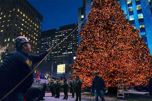 Per the court order, city workers take down the Christmas tree from New York's Rockefeller Plaza.