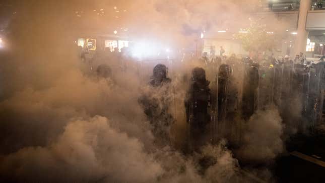 Riot police shrouded in gas on the streets of Hong Kong on July 21, 2019.