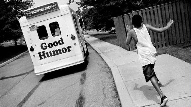 A 10-year-old boy runs as he yells for the ice cream truck to stop (it did). Laurel, Maryland, 1998