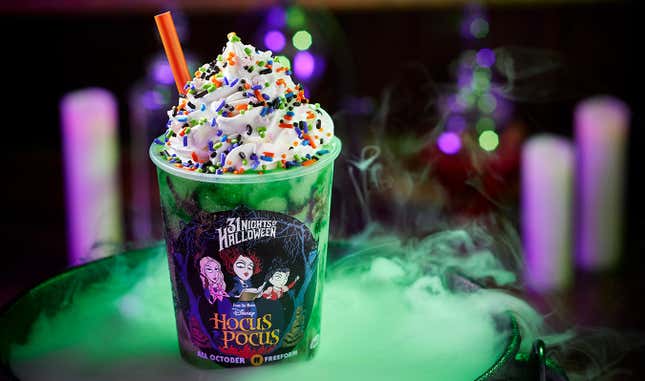 Milkshake in a Hocus Pocus promotional cup on top of a bubbling, steaming cauldron